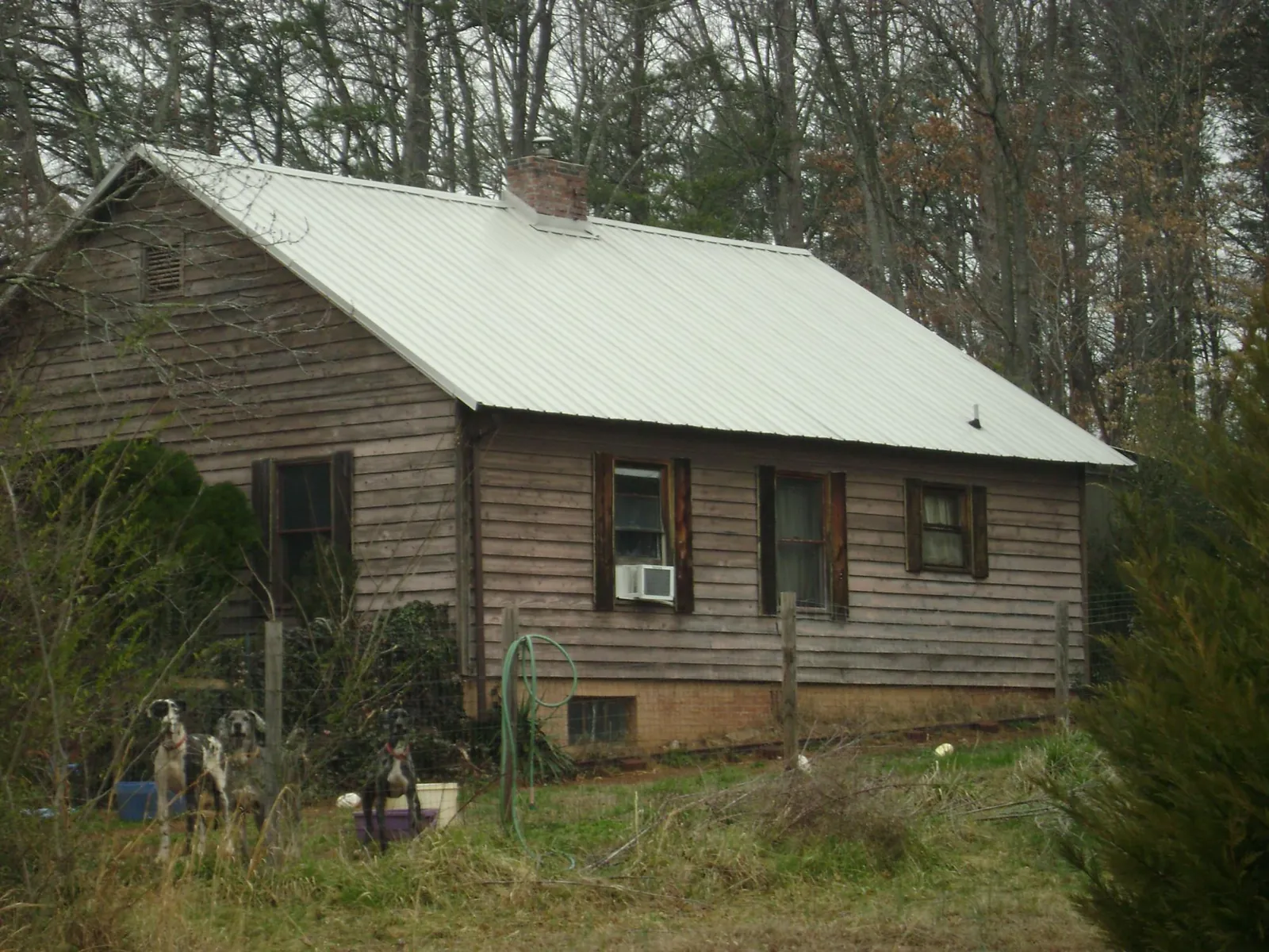 White metal roof on an old wood sided farmhouse, from a Metal Roof Installation job in Lincoln